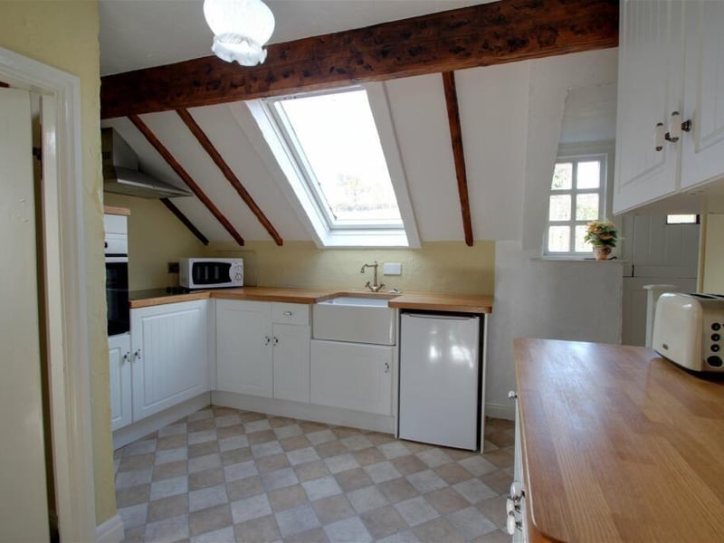 The kitchen in the annexe/cottage is fitted with a good range of base units, with butcher's block-style worktops. There is a Belfast sink with mixer tap, integrated oven, hob and space for a fridge/freezer.