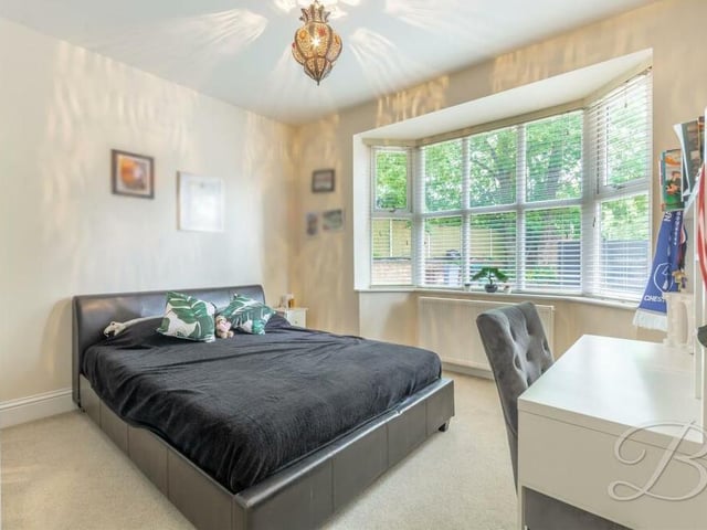 Three of the four bedrooms can be found on the ground floor, including this impressive one, which boasts a grand bay window facing the front of the property.