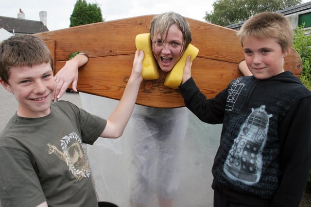 2007: New headteacher Donna Chambers is in the stocks at Greasley Beauvale Junior School's summer fair and is pictured with Jack Hardingham and Jake Humphries.