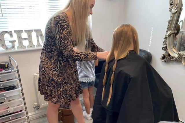 Grace at GHM Hair cutting Lydia's hair