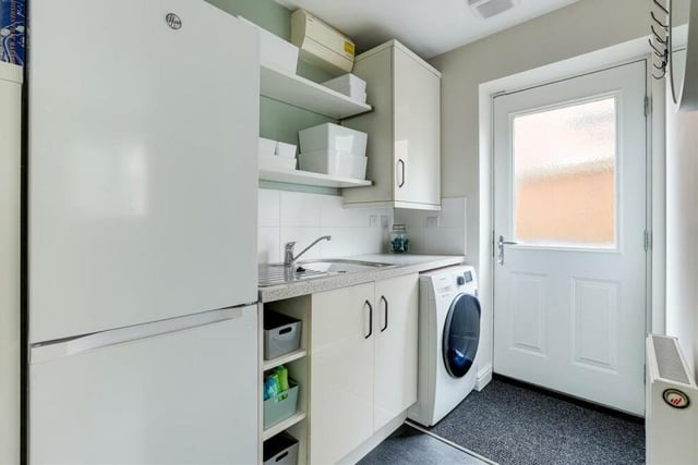 Just off the kitchen diner is this handy utility room, which has space and plumbing for a washing machine, and space for a fridge freezer. There are fitted base and wall units, a worktop and a stainless steel sink with mixer tap and drainer. The door leads out to the side of the house.