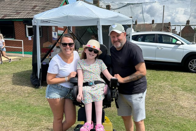 Evie's parents, Emma and Lee Wilson with Elsie. The Lashes Foundation helped Elsie fund her wheelchair.