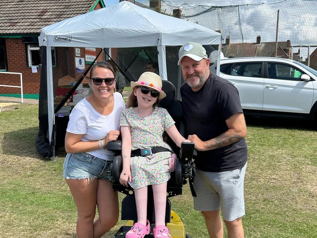 Evie's parents, Emma and Lee Wilson with Elsie. The Lashes Foundation helped Elsie fund her wheelchair.