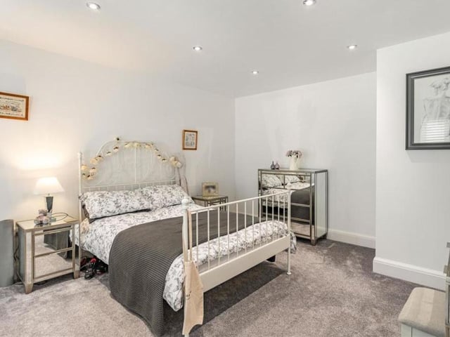 Although not seen here, the third bedroom also benefits from three floor-to-ceiling windows facing the front of the house. An elegant space, it has eight ceiling spotlights too.