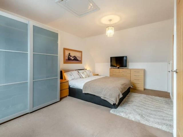 Time to go up to the second floor of the £395,000 house, where there are two more bedrooms and a family bathroom. This terrific bedroom, with wardrobe space, features a loft-hatch with a ladder that leads to a partially boarded loft. There is also a Velux roof window.