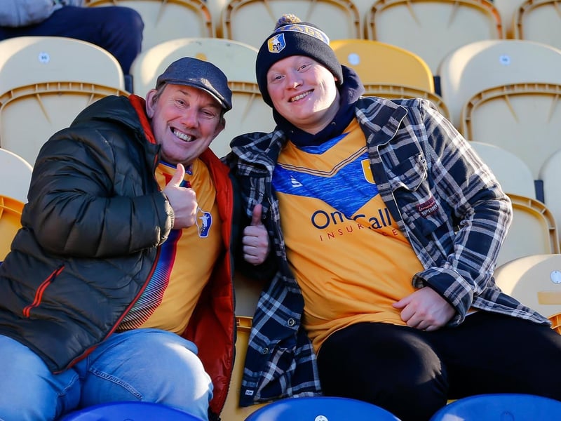 Mansfield Town fans watch their team win at home against Scunthorpe Utd.