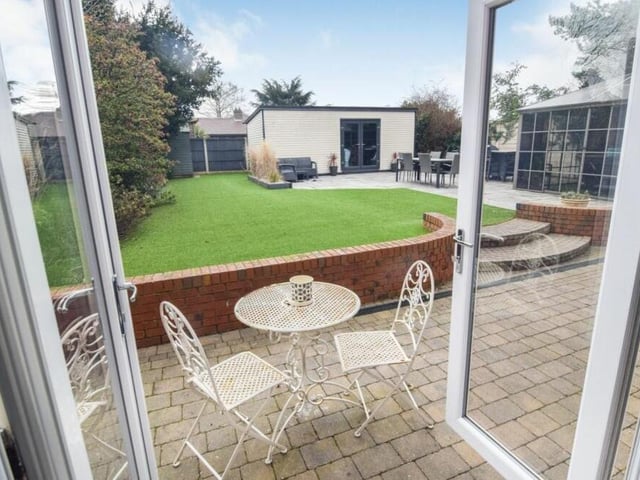 Doors in the lounge lead out to the garden at the back of the house and this delightful patio and seating area.