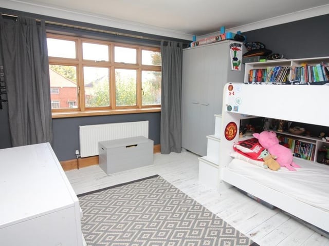 The other three bedrooms can also be found on the first floor. All are a good size and two of them have a built-in wardrobe, including this one, which faces the front of the £400,000-plus house.