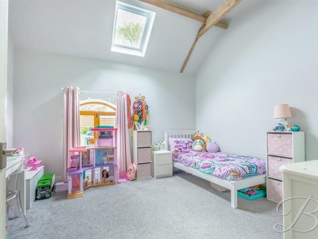 High ceilings are a feature throughout the £425,000-plus Huthwaite barn conversion, including in this bright and cheerful bedroom.