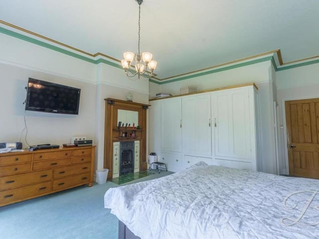 We begin our tour of the seven bedrooms with a look at the master. It has a feature fireplace, carpeted floor, coving and plenty of room for cupboards and wardrobes.