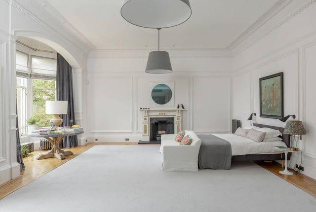 One of the eight bedrooms with a large bay window and its own fire place.