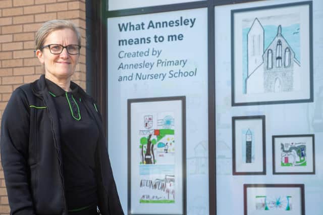 Store manager Jayne Hutsby in front of the artwork provided by Annesley Primary and Nursery School.