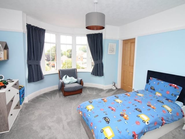Back to the first floor now to take a look at bedroom number two, which is bright and cheerful thanks largely to the large uPVC double-glazed bay window, which faces the front of the £400,000-plus property.