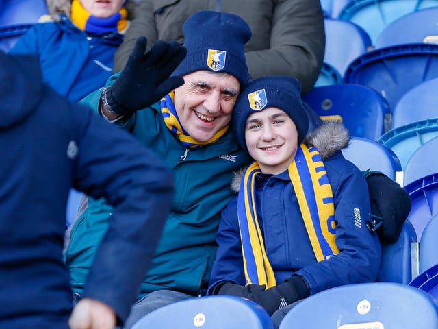 Mansfield Town fans watch the match against Northampton Town.