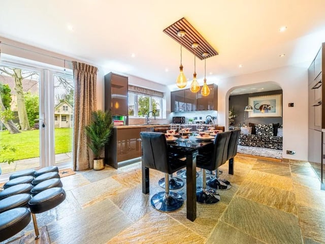 The stunning modern kitchen boasts lots of natural light thanks to the large window and French doors leading out onto the garden.