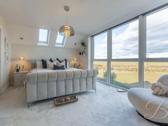 As we move upstairs, how about this for a stunning main double bedroom? A floor-to-ceiling window, facing the front of the house, offers amazing panoramic views.The floor is carpeted.