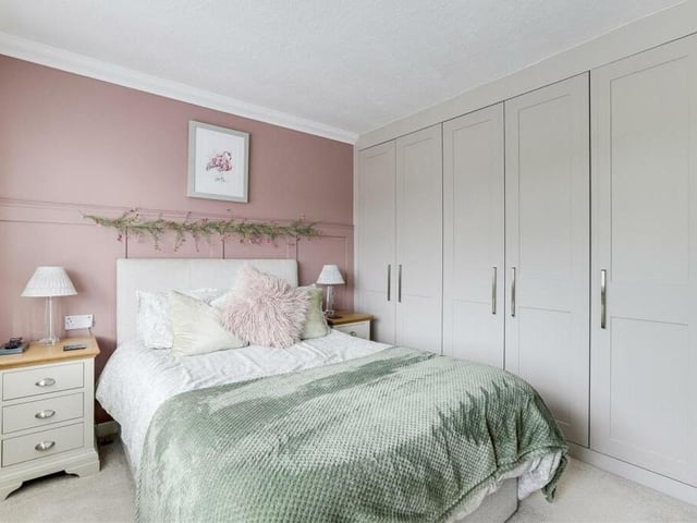 Another notable feature of the principal bedroom is fitted floor-to-ceiling wardrobes. There is also a TV point and coving to the ceiling.,