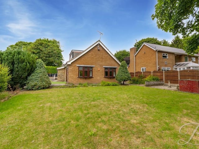 Let's step outside now, and take a look at the Kirkby House Drive bungalow from the side garden. The lawn has been well maintained.