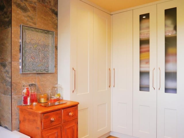 The cottage's bathroom is a room that just keeps on giving! It boasts two built-in wardrobes, wooden laminate flooring and recessed and ceiling spotlights.