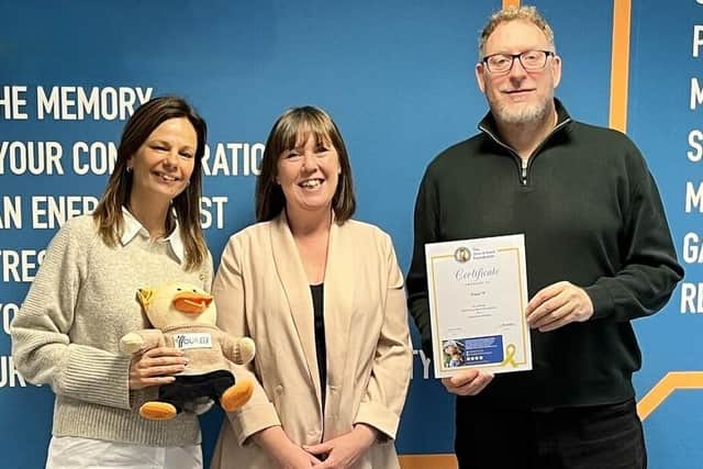 Stephanie McCawley (centre) from the Give A Duck Foundation is pictured with Sam and Lee Hewson from Your IT Department, along with the company’s own chemo duck and certificate. Photo: Submitted