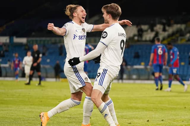 Leeds United's English striker Patrick Bamford (R) celebrates scoring his team's second goal with Leeds United's English defender Luke Ayling during the English Premier League football match between Leeds United and Crystal Palace at Elland Road in Leeds, northern England on February 8, 2021. (Photo by Jon Super / POOL / AFP) / RESTRICTED TO EDITORIAL USE. No use with unauthorized audio, video, data, fixture lists, club/league logos or 'live' services. Online in-match use limited to 120 images. An additional 40 images may be used in extra time. No video emulation. Social media in-match use limited to 120 images. An additional 40 images may be used in extra time. No use in betting publications, games or single club/league/player publications. /  (Photo by JON SUPER/POOL/AFP via Getty Images)