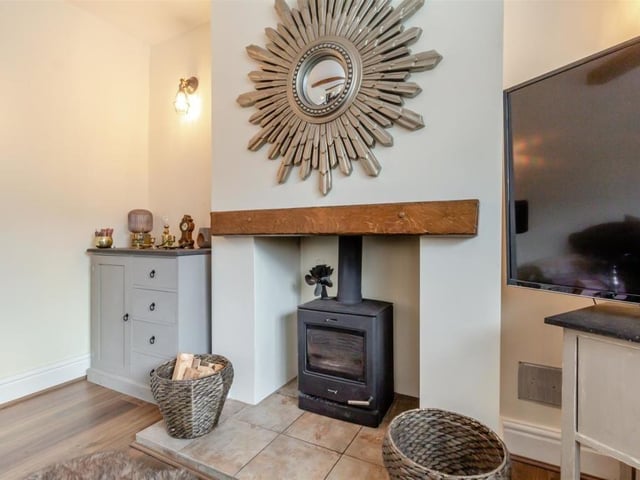 Here is a close-up of the log burner, with tiled hearth and oak mantle above, in the lounge.