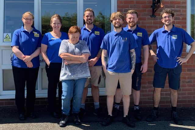 Centre manager, Jane Holt and deputy manager, Jordan Lee pose with proud team.