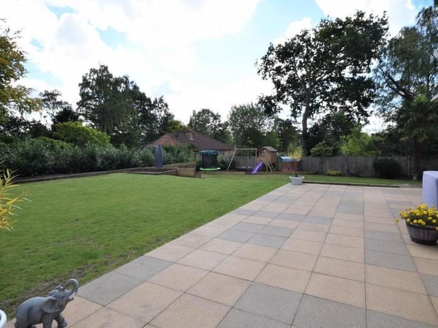 The back garden includes many defined areas to enjoy, including this pleasant patio, which offers plenty of space for relaxing and entertaining.