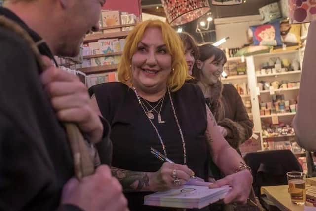 Photo of Lisa McKenzie at a book signing in Tooting Market, London, by Peter Marshall.