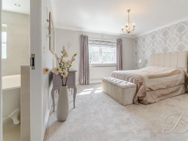 This bedroom offers carpeted flooring, fitted wardrobes for ample storage, and the added benefit of a private en suite.