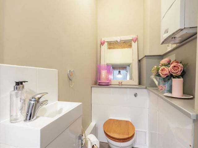 Off the kitchen/diner is this downstairs toilet, comprising a low-flush WC and wall-hung wash hand basin. There is also a storage cupboard and wall-mounted Worcester Bosch gas central heating boiler.