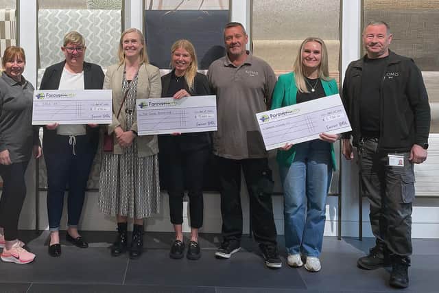 The ROMO team present a cheque to their Community Fund recipients, including Lisa Lenton, representing S.H.E. UK (third from left)