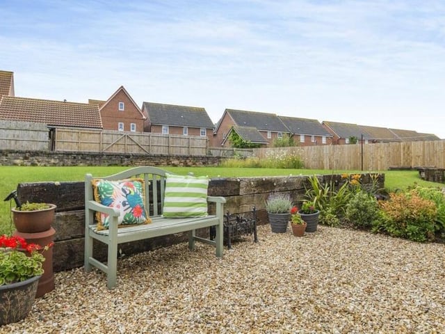 Sit back and relax -- cushions and all! A nice spot to have a minute within the rear garden.
