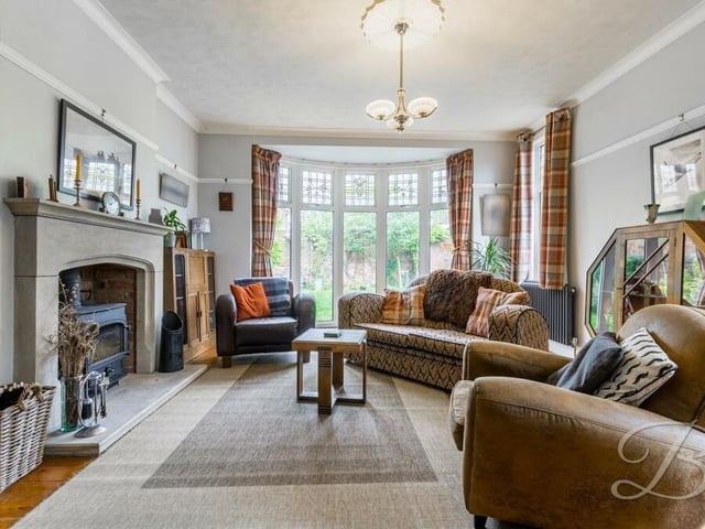 There's only one place to start our tour of the £400,000 Jacksdale property -- and that's in this lovely living room. It oozes character thanks largely to its large bay window, which overlooks the rear garden, coving and feature fireplace with log-burner