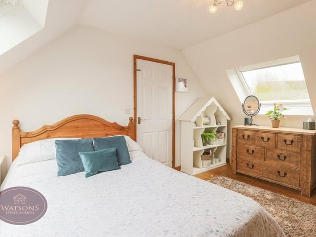 Up to the second floor now to find this pleasant double bedroom, with an exposed wooden floor, integrated eaves storage and Velux windows offering countryside views