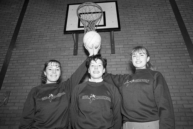 Three netball players proudly wearing their new Gus Robinson sponsored kit. But who were they?