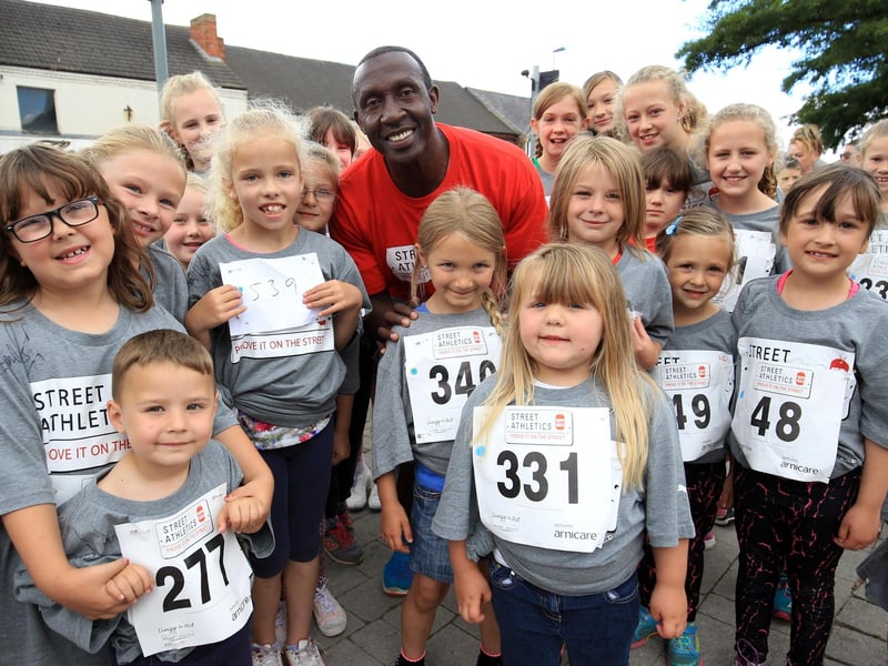 Linford Christie poses for pictures with some of the competitors.