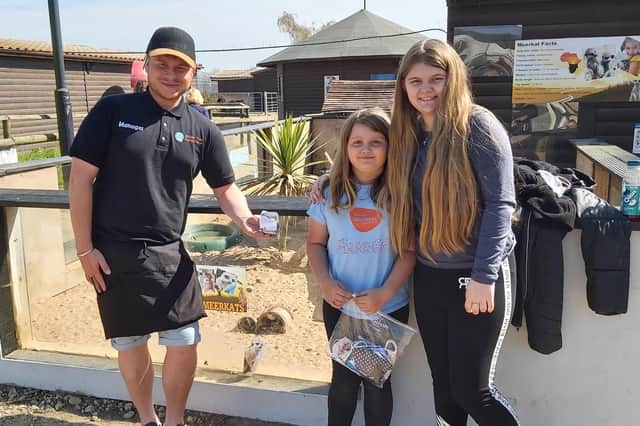 Millie (centre) and cousin Chloe with volunteer director David Taylor outside the meerkats' enclosure at Willow Tree Family Farm in Shirebrook.