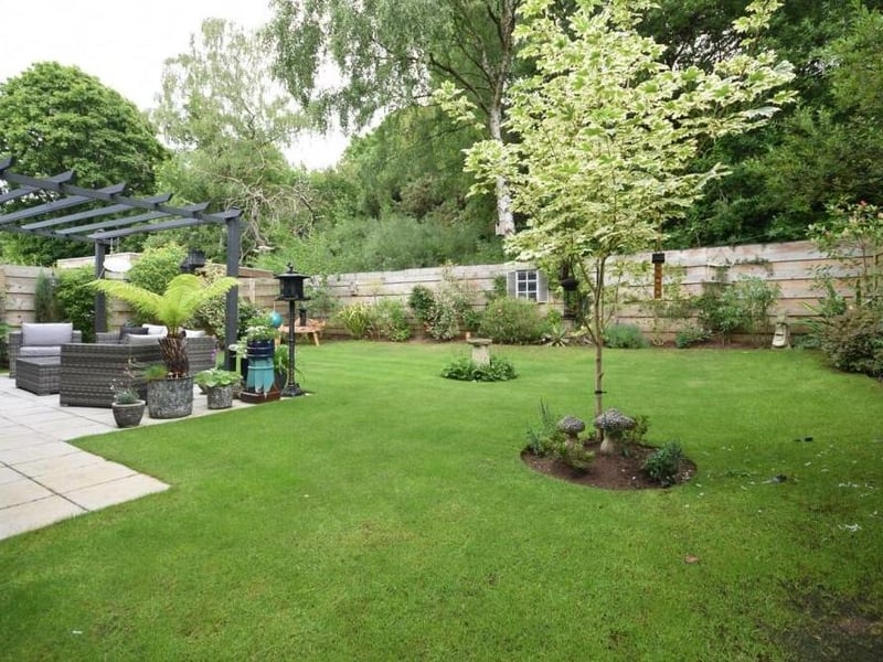 Time for a quick peek outside now, and here is the beautiful back garden, with its neat lawn, patio area, plants and shrubs. All enclosed by a secure perimeter fence for privacy.