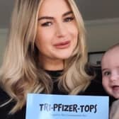 Jade with baby Walter and her new book, 'Tri-Pfizer-Tops'.