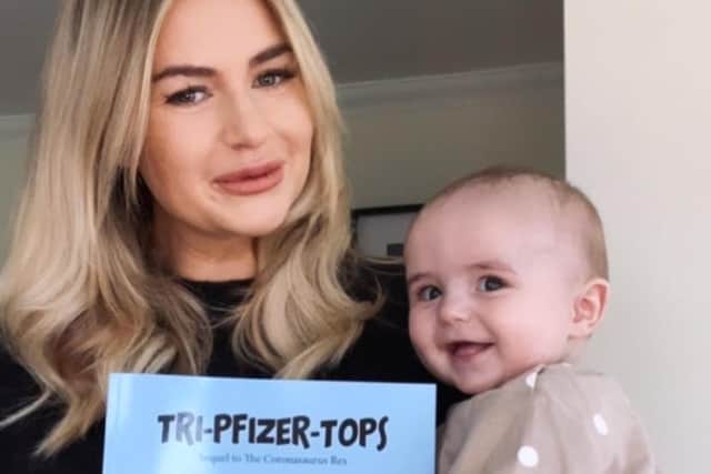 Jade with baby Walter and her new book, 'Tri-Pfizer-Tops'.