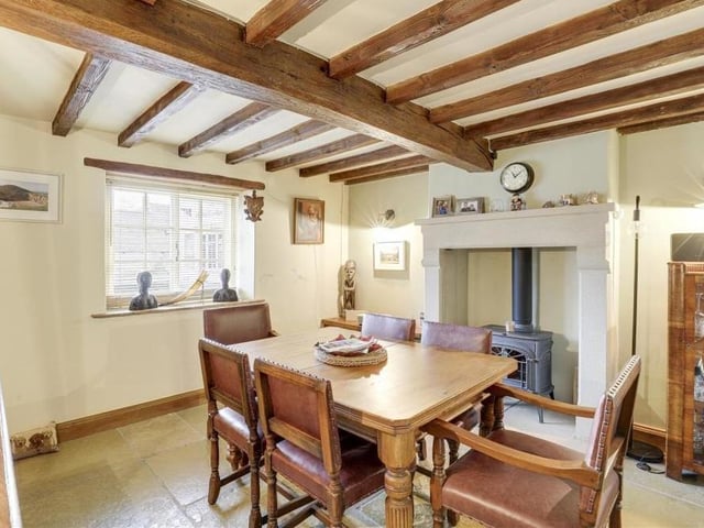 The dining room also features an eyecatching, recessed chimney-breast alcove with the potential for a log-burner. A wood-framed sash window adds character.