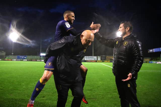 Jordan Bowery celebrates victory at Forest Green Rovers with manager Nigel Clough and first team coach Andy Garner.