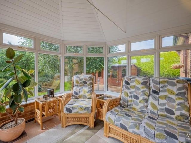 The colourful conservatory is a relaxing space that offers lovely views of, and access to, the garden.