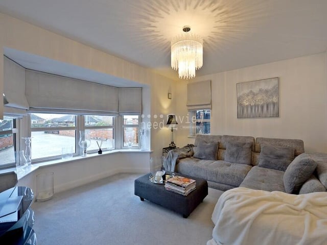 Let's begin our tour of the property in the first of two reception room lounges. This comfortable one is spacious, with uPVC double-glazed windows to the front and side of the house, including a splendid bay.