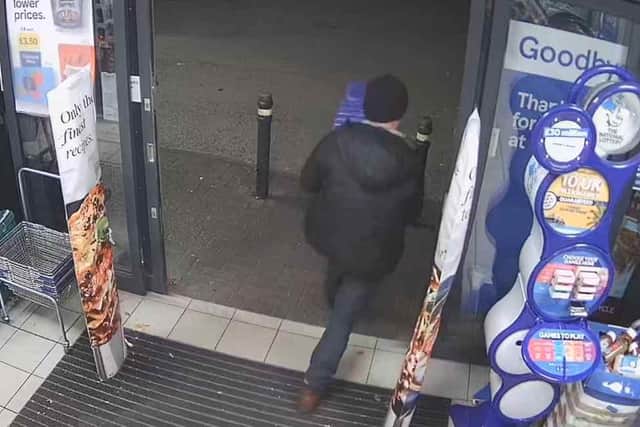 Warren Staniforth pictured walking out of a shop with Advent calendars.