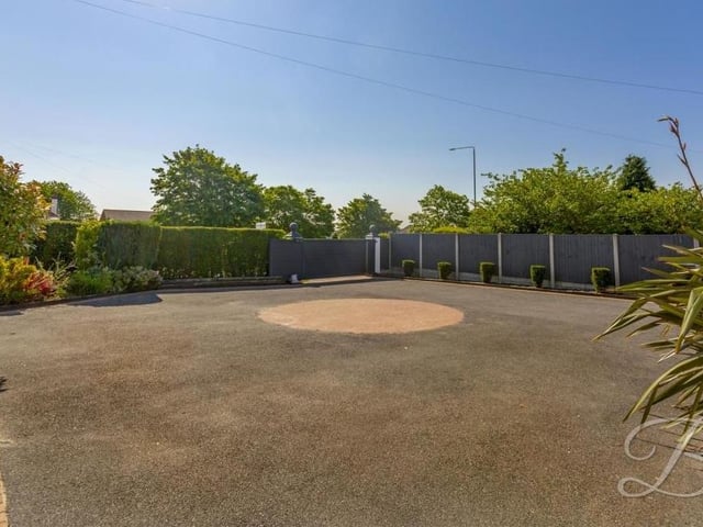 A view from the front door, showing how spacious the carriage driveway is, with its turning point in the centre.