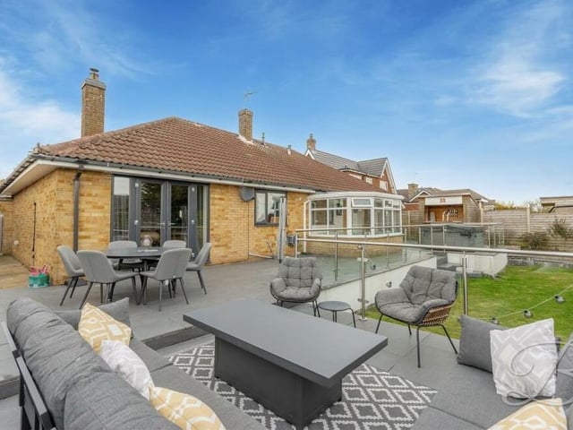 Let's move outside now and what better place to start than this superb raised patio seating area with glass balustrade and modern floor tiles? Perfect for al fresco gatherings with family and friends.