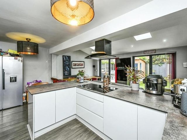 Integrated appliances within the kitchen/diner include a five-ring induction hob, an extractor fan, an oven and microwave, and a dishwasher. There is space too for an American-style fridge freezer.