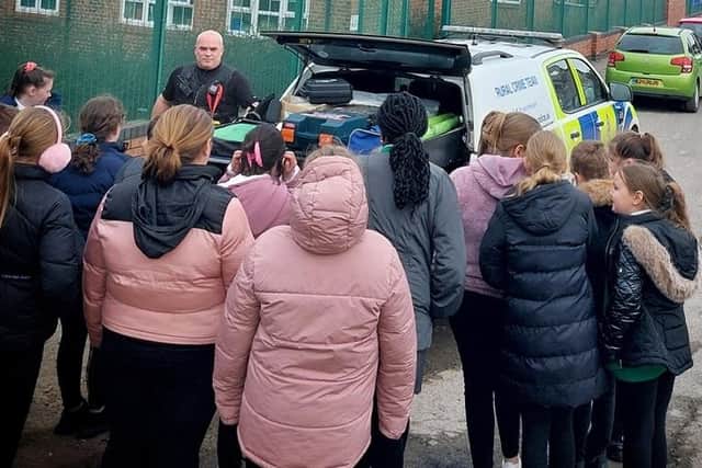 PC Emerson Buckingham with mini police and the rural police team vehicle.